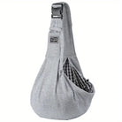 Gray pet carrier sling bag with adjustable strap and checkered interior, featuring a secure buckle and zippered pocket. Ideal for small pets.