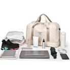 Travel essentials flat lay featuring a beige duffel bag, laptop, sneakers, water bottle, and toiletries. Perfect for packing, organization, and travel gear.