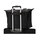 Black travel tote bag securely attached to a rolling suitcase handle, ideal for convenient airport travel. Durable, spacious, and stylish luggage accessory.