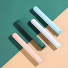 Four sleek, modern electric toothbrushes in pastel colors on a two-tone background. Ideal for oral hygiene, dental care, and stylish bathroom accessories.