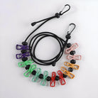 Colorful travel clothesline with 12 plastic clips and adjustable bungee cord, featuring carabiner hooks for easy hanging. Ideal for camping and travel.