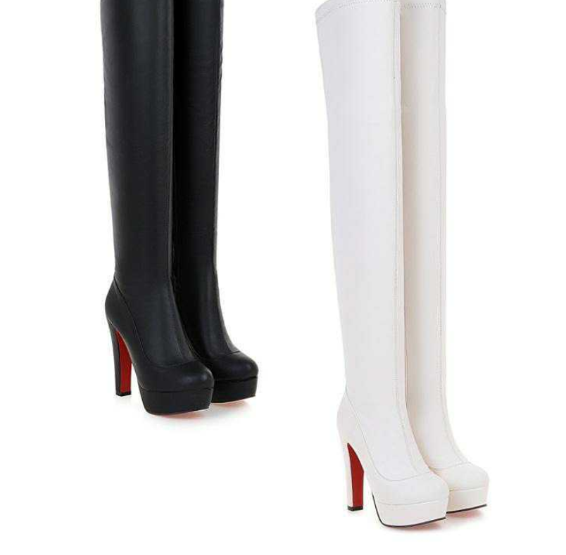 Black and white thigh-high platform boots with red soles, high heels, and sleek design, perfect for fashion-forward style and statement footwear.