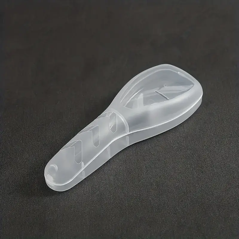 Transparent plastic shoehorn on dark background, ergonomic design, durable material, ideal for easy shoe wearing, essential footwear accessory.