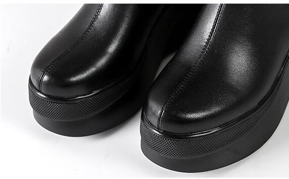 Black leather platform boots with sleek design and textured soles, showcasing modern fashion footwear trends. Perfect for stylish, edgy looks.