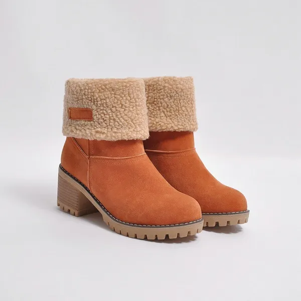 Women's tan suede ankle boots with faux fur lining, block heel, and lug sole. Stylish winter footwear, perfect for casual and outdoor wear.