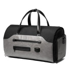 Sleek black and gray duffel bag with leather handles, multiple zippered compartments, and durable design. Perfect for travel, gym, or weekend trips.