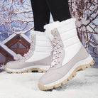 White and gray winter snow boots with fur lining, durable soles, and red laces, perfect for cold weather. Snowy background enhances winter theme.