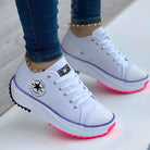 White platform sneakers with LED pink soles, star logo, and gold anklet detail. Trendy women's fashion footwear, casual style, comfortable design.