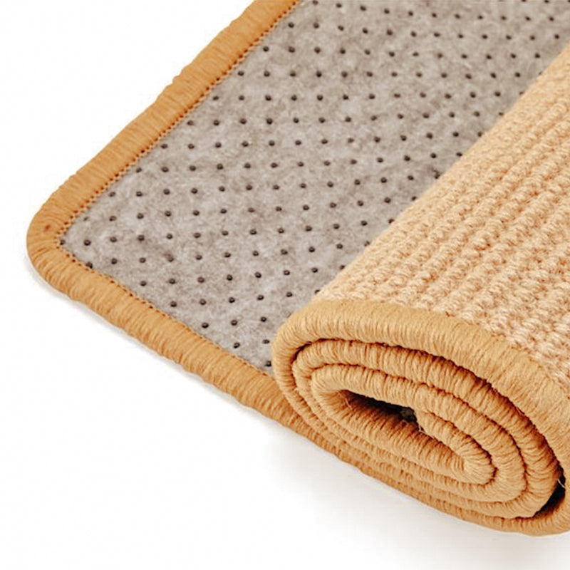 Rolled beige non-slip bath mat with textured surface and dotted anti-skid backing, ideal for bathroom safety and comfort.