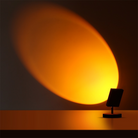 Modern sunset projection lamp casting warm orange light on wall, creating ambient mood lighting. Ideal for home decor, relaxation, and photography.