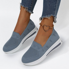 Women's blue slip-on sneakers with white soles, featuring a heart-shaped anklet. Casual, breathable mesh design, perfect for everyday wear.