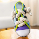 Colorful sneaker-shaped dog toy with durable rope laces, designed for interactive play and dental health. Perfect for active pets.