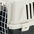 Plastic pet carrier with secure latch, ventilation slits, and metal wire door. Ideal for safe pet transport. Durable, portable pet travel crate.