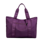 Purple travel duffel bag with front zipper pocket and sturdy handles, ideal for gym, weekend trips, and carry-on luggage. Durable and stylish design.