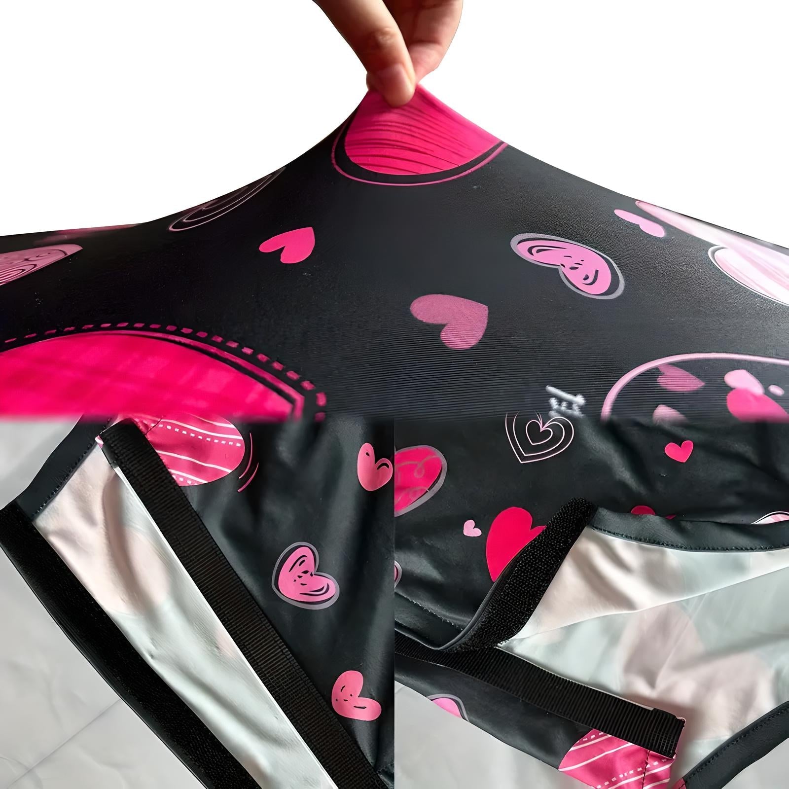 Close-up of a black and pink heart-patterned umbrella fabric, showcasing waterproof material and durable construction. Perfect for stylish rain protection.