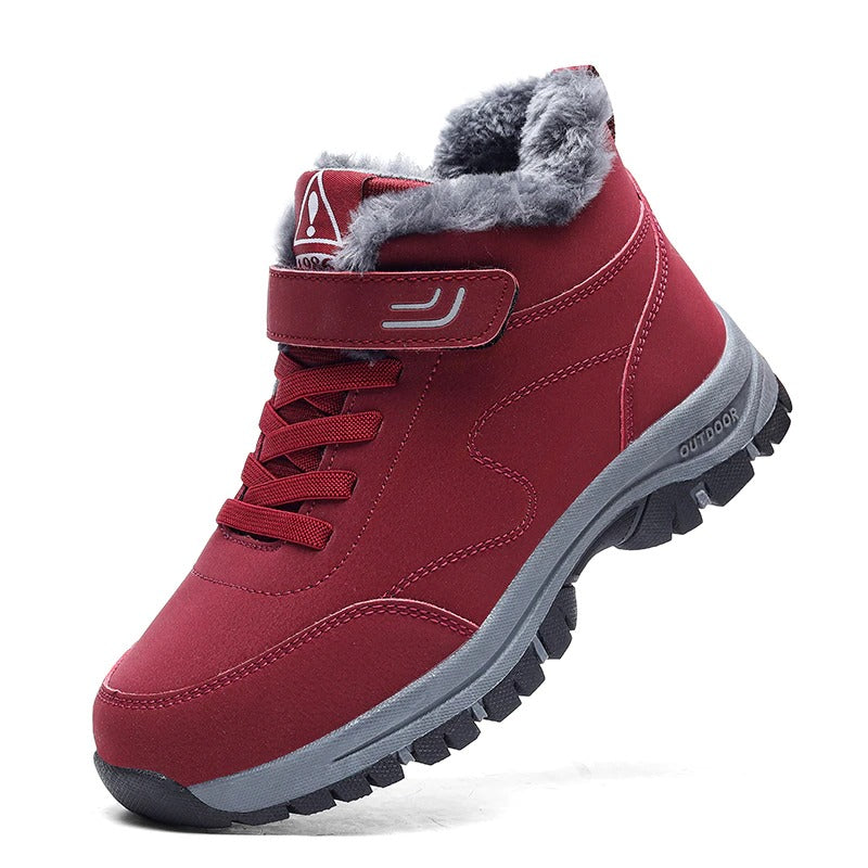 Red winter boot with plush lining, lace-up and Velcro closure, durable sole. Ideal for outdoor activities. Women's and men's sizes available.