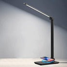 Sleek LED desk lamp with wireless phone charging pad, adjustable arm, modern design, energy-efficient lighting, perfect for home office use.