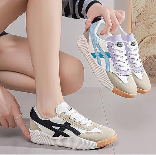 Stylish retro sneakers with distinctive wave sole design, featuring black and blue stripes. Perfect for casual wear and fashion-forward looks.