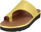 Yellow leather slide sandal with open toe design, cushioned brown footbed, and black rubber sole. Comfortable summer footwear for women.