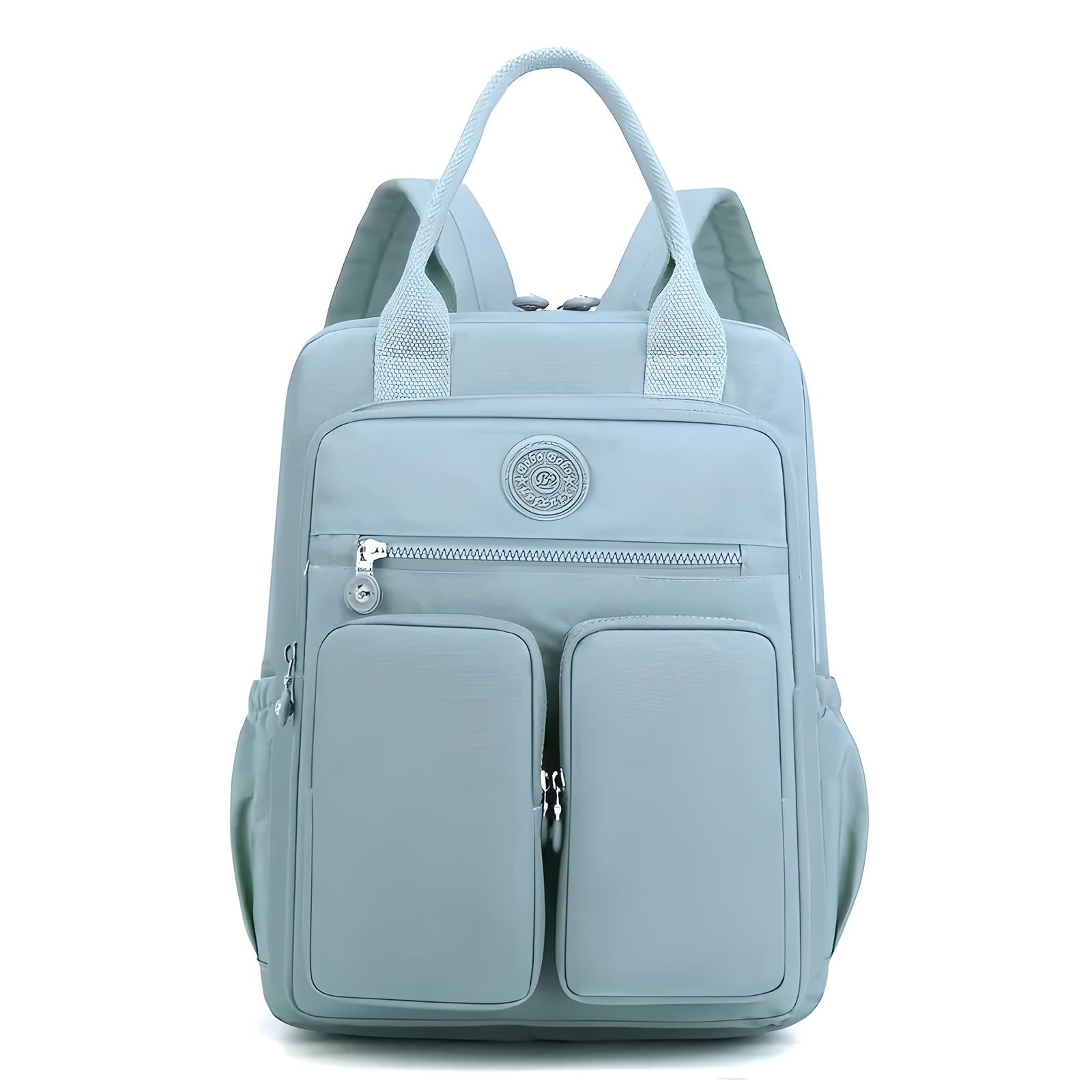 Light blue backpack with dual front zippered pockets, top handles, and adjustable shoulder straps. Stylish, functional, and perfect for travel or school.