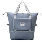 Stylish gray insulated cooler bag with front pocket and durable handles, perfect for picnics, beach trips, and outdoor activities.