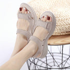 Women's beige orthopedic sandals with adjustable straps, cushioned sole, and open-toe design, perfect for comfort and style.