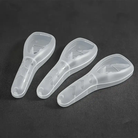 Three transparent plastic shoehorns on a dark background, featuring ergonomic handles and sleek design. Ideal for easy shoe wearing.