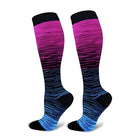 Colorful gradient knee-high compression socks with pink, purple, and blue stripes, designed for comfort and support. Ideal for sports and travel.