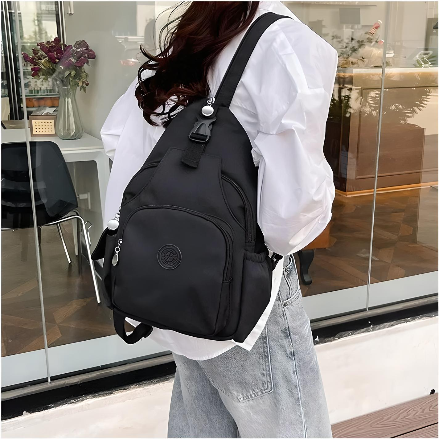 Woman wearing a stylish black backpack with multiple compartments, perfect for travel and daily use. Fashionable accessory for modern urban lifestyle.