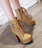 Tan high-heeled ankle boots with lace-up front, double buckle straps, and platform sole on a tiled floor. Fashionable women's footwear.