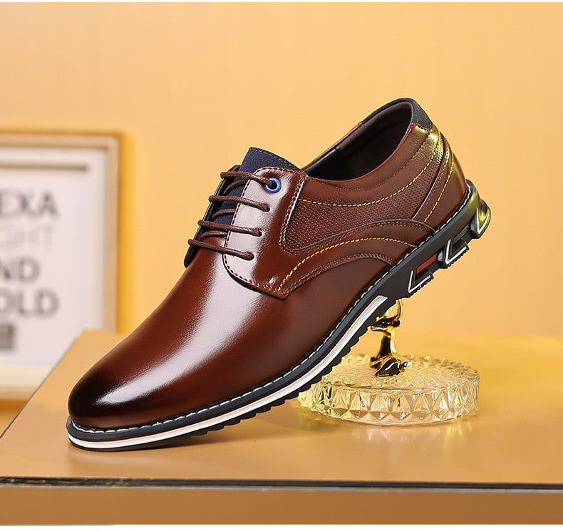 Brown leather men's dress shoe with lace-up design, featuring a sleek finish and modern sole, displayed on a decorative stand. Perfect for formal occasions.