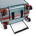 Blue hard-shell suitcase with brown wheels and a transparent protective cover, featuring a zippered compartment and durable spinner wheels.