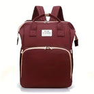 Maroon backpack with front pocket, dual zippers, and top handles. Stylish and functional design for travel or school. Durable and spacious.