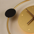 Modern minimalist gold wall clock with black accents, featuring a circular design and wooden hands. Stylish home decor, contemporary timepiece.