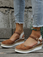 Women's brown suede espadrille wedges with ankle straps, paired with distressed jeans. Stylish summer footwear, casual fashion, comfortable platform shoes.