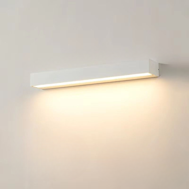 Modern white LED wall light fixture, minimalist rectangular design, emits warm ambient glow, ideal for home interior lighting and energy efficiency.