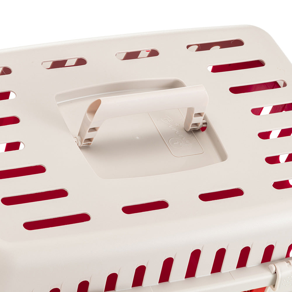 Pet carrier top view with beige plastic handle and ventilation slots, ideal for safe pet transport. Durable, lightweight, and easy to carry.