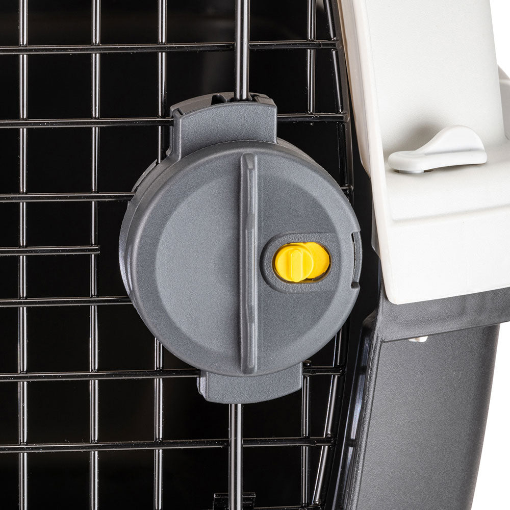 Pet carrier door latch close-up, featuring a secure gray locking mechanism with a yellow safety button, ideal for safe pet transportation.