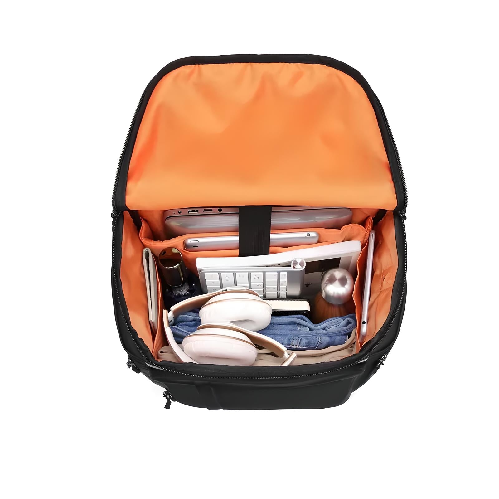 Open black backpack with orange interior, organized compartments holding a laptop, tablet, headphones, keyboard, and accessories. Ideal for tech travel.