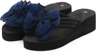 Black platform flip-flops with blue bow accents, featuring cushioned straps and non-slip soles. Stylish women's summer footwear, perfect for casual wear.