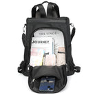 Black backpack with open compartments displaying a magazine, phone, wallet, and travel essentials. Stylish, functional travel backpack for daily use.