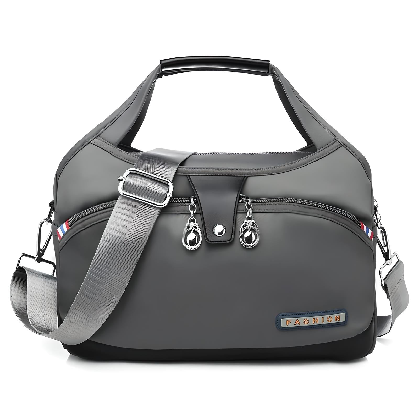 Stylish gray fashion handbag with adjustable shoulder strap, multiple zippered compartments, and sleek design. Perfect for travel or daily use.