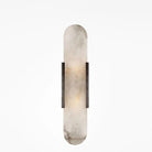 Modern wall sconce with elongated oval alabaster shade and black metal accents, ideal for contemporary home lighting and interior design.