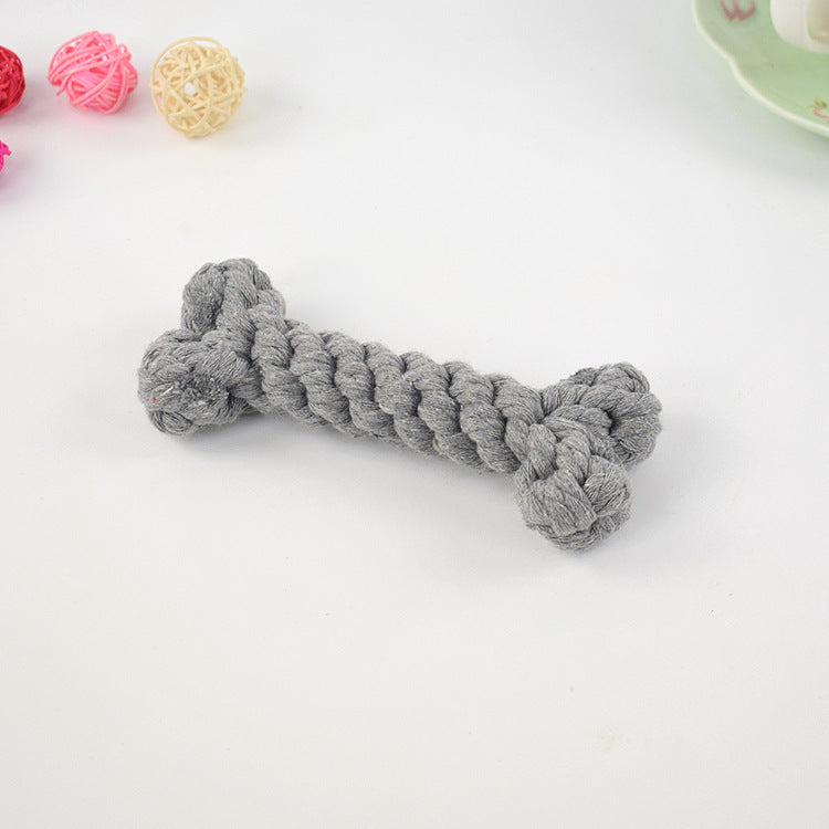 Gray rope dog toy shaped like a bone on a white background, surrounded by colorful decorative balls. Durable pet chew toy for playful dogs.