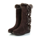 Brown suede winter boots with faux fur trim and wedge heel, featuring side buckle details. Perfect for cold weather fashion and comfort.