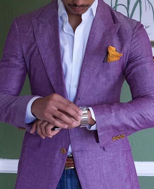 Man in purple linen blazer with white shirt, yellow pocket square, adjusting silver watch.