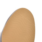 Close-up of a beige rubber shoe sole with textured grip pattern, highlighting durability and slip resistance. Ideal for footwear enthusiasts and shoppers.