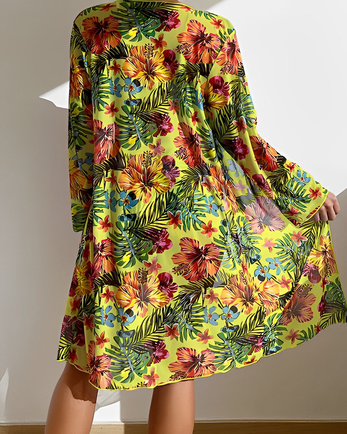 Vibrant floral print dress with tropical patterns, featuring bold yellow, red, and green hues. Perfect for summer fashion and beachwear styling.