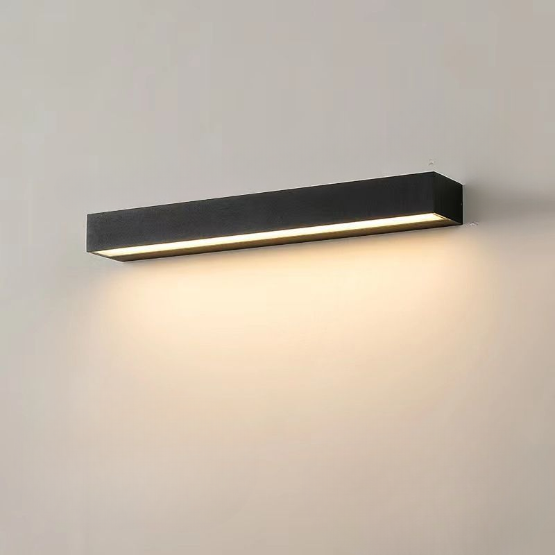 Modern black LED wall sconce with minimalist design, illuminating a soft warm light. Ideal for contemporary home lighting and energy-efficient decor.