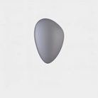 Gray ergonomic pebble-shaped wireless computer mouse on white background, minimalist design, modern tech accessory, sleek and compact.